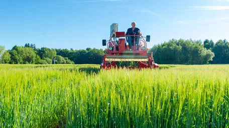 Farmer on heavy machinery doing fieldwork
